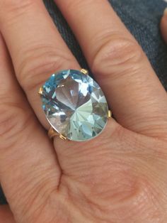 This beautiful vintage ring was found in southern Indiana, close to the Kentucky border. This goreous ring weighs 9.6 grams, and the oval Swiss Blue Topaz measures 20x16mm. That's approximately 15 carats! If you want a classic statement ring, this is it. I'ts a size 6 1/2. Classic Oval Topaz Ring, Classic Oval Topaz Birthstone Ring, Formal Oval Ring With Large Stone, Oval Large Stone Topaz Ring For Anniversary, Oval Topaz Ring With Large Stone For Anniversary, Formal Oval Topaz Ring, Large Stone Topaz Ring In Fine Jewelry Style, Formal Oval Hallmarked Topaz Ring, Large Stone Topaz Ring Fine Jewelry