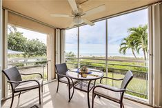 two chairs and a table on a balcony