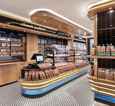 a bakery filled with lots of different types of breads and pastries on display