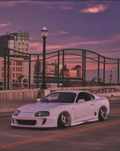 a white car parked on the side of a road