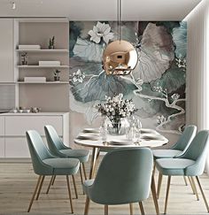 a dining room table with blue chairs and a floral wallpaper behind it in an apartment