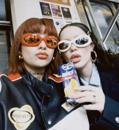 two women in sunglasses are posing for the camera