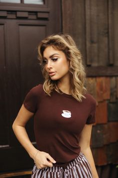 Chic brown top featuring a fan favorite cup of coffee!  Feature:  Scoop neckline  Cinched Waist Embroidery Model wearing a size small.  Materials & Care Content: 95% Cotton, 5% Elastic Coffee Tees, Brown Top, Cup Of Coffee, Cinched Waist, Scoop Neckline, Womens Clothing Tops, Tops & Tees, Models, T Shirts