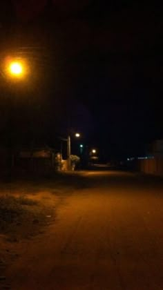 an empty road at night with street lights