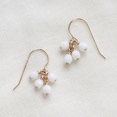 lucky in white  faceted gold earrings by elephantine on Etsy White Pearl Drop Dangle Cluster Earrings, White Pearl Drop Cluster Earrings, Minimalist White Beaded Dangle Earrings, Simple White Drop Earrings, Minimalist White Earrings With French Hook, Minimalist White Beaded Drop Earrings, White Minimalist French Hook Earrings, Minimalist White French Hook Earrings, White Dangle Earrings With French Hook