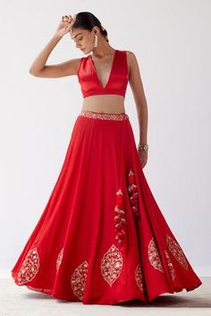 Red lehenga with floral motifs in dori and sequin embroidery. Paired with sleeveless blouse and embroidered sheer dupatta.
Component: 3
Pattern: Embroidered
Type Of Work: Sequins,Dori
Neckline: Plunge V Neck
Sleeve Type: Sleeveless
Fabric: Gajji Silk, Cotton Silk Satin And Silk Organza
Color: Red
Other Details: 
Organza dupatta
Sequin and resham work
Tassel detail
Occasion: Wedding - Aza Fashions Red Sleeveless Lehenga For Weddings, Sleeveless Red Lehenga For Wedding, Red Lehenga For Wedding, Red Sleeveless Choli For Reception, Sleeveless Red Choli For Reception, Sleeveless Red Lehenga For Diwali, Red Sleeveless Lehenga With Zari Work, Red Lehenga For Navratri, Red Sharara With Floral Embroidery For Wedding