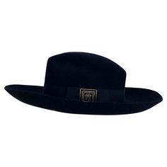 Presenting a versatile floppy Gianni Versace hat designed by Donatella Versace. From the early 2000s, this hat can be worn down as a floppy hat or with the brim turned up for a more structured look. The ribbon around the base of the hat is outfitted with a metal and enamel Greek key buckle, which is present on many of Donatella's creations during this period. Approximate measurements: Size - L Height: 4.5” Width: 14” Depth: 15.75” Greek Key buckle: 1.4" X 1.4" Classic Wide Brim Felt Hat For Evening, Classic Wide Brim Hat For Evening, Classic Evening Felt Hat For Kentucky Derby, Classic Kentucky Derby Evening Felt Hat, Classic Boater Hat With Short Brim For Evening, Classic Felt Hat For Kentucky Derby Evening, Classic Wide Brim Cloche Hat For Formal Occasions, Classic Short Brim Hats For Evening, Classic Wide Brim Boater Hat For Evening