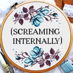 a cross stitch pattern with the words screaming intensely on it and some sewing supplies next to it