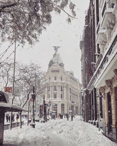 a snowy street with people walking on it