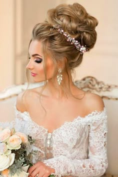 a woman sitting on a couch with flowers in her hair and wearing a wedding dress