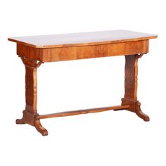 an old wooden table with a white top