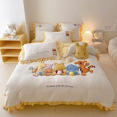 a bed with winnie the pooh comforter and pillows