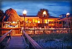 a boardwalk leading to a restaurant at night