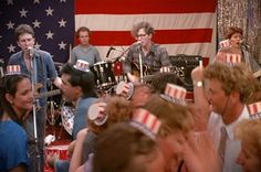 a group of people with patriotic hats on their heads in front of an american flag