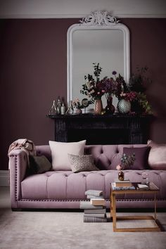 a living room with purple walls and furniture