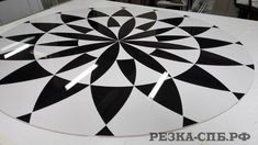 a black and white circular design on the floor