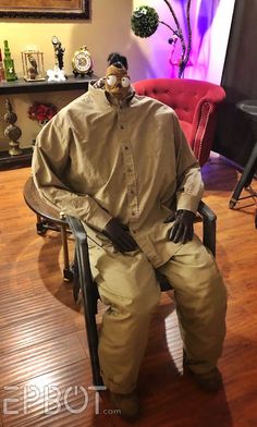 a man sitting on top of a chair in a living room