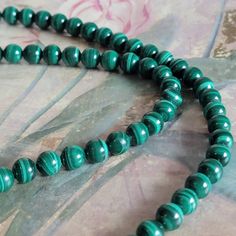 This is a vintage, malachite bead necklace. There is a bit of space on the necklace (meaning you can see about 5 mm of the stringing thread). It has a screw closure. All sales are final. This measures 20 inches long x 8 mm. If you have a wish list or are looking for something specific, please ask. I may have exactly what you are looking for. As always please convo me with any questions or concerns regarding this item or with any international shipping questions. Unfortunately I do not accept returns or grant refunds. All shipping fees include handling fees. If you would like to combine shipping costs for more than one item, I would be happy to do so if you convo me before purchase. Purchasing my item means you have read, understood and will abide by my policies. Sorry, I do not accept trad Malachite Gemstone Bead Necklaces, Malachite Gemstone Beads Necklace, Beaded Malachite Round Bead Necklaces, Polished Malachite Round Beaded Necklaces, Round Malachite Beaded Necklace, Malachite Gemstone Beaded Necklaces, Green Malachite Round Beads, Healing Malachite Beaded Necklaces With Round Beads, Necklace Meaning