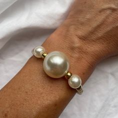 This pearl bracelet is the perfect gift idea for a birthday or mothers day gift. Bracelet is made with freshwater pearls, filled with 14k gold beaded style.A beautiful bracelet for the chic, timeless and stylish women to wear daily. Please avoid contact with perfume, soap, salty or chlorine water. The pearls can be cleaned with slightly wet soft piece of cloth. Pearls of different sizes in combination with gold-plated beads. - Handmade item - Materials: freshwater pearls, brass, 18k gold plated Elegant Cream Pearl Bracelet As A Gift, Elegant Cream Pearl Bracelet As Gift, Elegant Cream Pearl Bracelet Gift, Adjustable Hypoallergenic Pearl Bracelet For Anniversary, Elegant Handmade Bracelets For Birthday, Adjustable Bangle Pearl Bracelet Gift, Adjustable Pearl Bangle Bracelet Gift, Elegant White Bracelets For Birthday, White Single Strand Beaded Bracelet For Gift