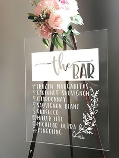 a sign that has some flowers on it with the word bar written in different languages