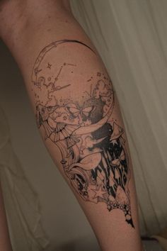 a tattoo on the leg of a person with a cat and moon in the background