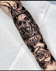 a man's arm with a skull and roses tattoo on it, which reads faith