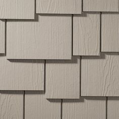 a close up view of the white siding on a wooden building with gray shingles