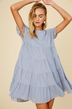 -Color: Misty Blue -Linen textured cotton woven fabric -Round neck -Ruffle short sleeves -Keyhole on back with button -Side seam pockets -Lined -Imported -Maternity friendly style -Content: Self 100% Cotton, Lining 100% Polyester -Runs true to size -Model is 5' 10" 33-24-35 and wearing a size Small Cotton Short Sleeve Dress For Spring Day Out, Cotton Short Sleeve Dress For Day Out, Summer Tiered Maternity Dress, Cotton Dresses For Day Out With Short Sleeves, Cotton Dress For Day Out With Short Sleeves, Maternity Dresses With Short Sleeves, Casual Ruffled Short Sleeve Dress For Day Out, Casual Short Sleeve Dress With Ruffles For Day Out, Modest Cotton Dress With Ruffles