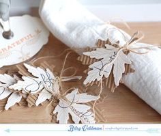 the napkins are tied up and ready to be put into the fall leaves place card holders