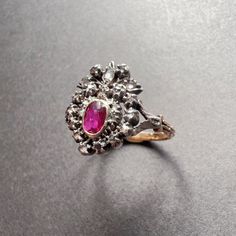 For best prices and offers, please visit our website at https://curiouslytimeless.com/ For sale a 19th century 18K gold ring featuring a crowned heart. The center of the heart is made of an oval shaped ruby of a deep purplish red color. The gem is surrounded by numerous rose cut diamonds. The gemstones are set with open backs and are firstly mounted on silver and then on 18K yellow gold. This type of ring was given in betrothal or during a wedding ceremony, as diamonds are associated with marria Victorian Oval Ruby Ring, Victorian Ruby Ring With Rose Cut Diamonds For Wedding, Heirloom Oval Rings For Valentine's Day, Valentine's Day Heirloom Oval Rings, Victorian Ruby Ring For Wedding, Victorian Ruby Ring With Center Stone, Oval Rings With Historical Design For Wedding, Oval Rings With Historical Design For Anniversary, Oval Wedding Rings With Historical Design