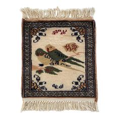 an embroidered rug with two birds on it