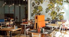 an empty restaurant with many tables and chairs