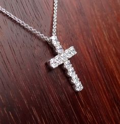 "This 18k white gold pendant is a high quality cross. This cross pendant is 23mm height by 15mm width made in 18k white gold approximately 5.5 grams total weight. It has 11 quality diamonds VS2 - SI1 clarity and G-H color range 1.10 cts total weight. The Italian 18k white gold chain can be 16,17 or 18 inch long . We love these pendant because it represents the way jewelry should be made with craftsmanship and quality. This pendent is anything but ordinary. Our pieces are designed and made with c Timeless Jewelry Gift, Gold Platinum Necklace Gift, White Gold Jewelry As Gift, Aaa Quality White Gold Jewelry As Gift, Luxury Diamond Cut Cross Jewelry, Timeless Cross Pendant Jewelry For Anniversary, Luxury Cross-shaped Diamond Cut Jewelry, Aaa Quality Diamond Necklace For Anniversary, Classic Formal Cross Pendant Jewelry