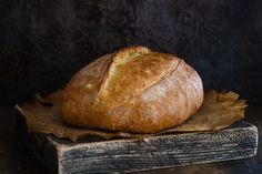 a loaf of bread sitting on top of a wooden block