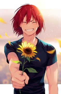 a man with red hair holding a sunflower