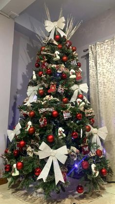 a decorated christmas tree with red and white ornaments