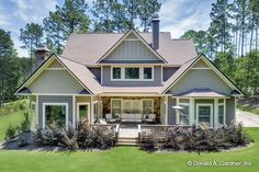 a large house sitting in the middle of a lush green field with lots of trees