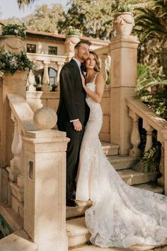 a bride and groom standing on the steps at their wedding venue in palm springs, florida