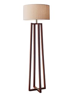 a wooden floor lamp with a beige shade on it's side and a white background