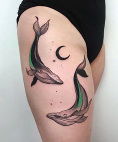 a woman's thigh with two whale tattoos on it