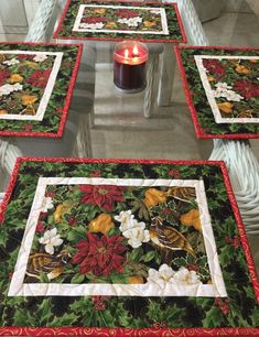 four quilted tables with candles on them