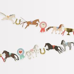 several paper horses are lined up in a row