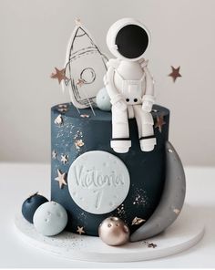 a birthday cake with an astronaut on top