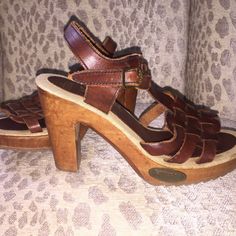 Vtg 1970’s Fanfares. New Never Worn, Handmade Brazilian Leather And Hand Carved Wood Heels. (Imperfections Are Its Character) New Clean Vintage Condition. Deep Oxblood, Burgundy, Rust Woven Huarache Top With A Brass Buckle Strap Around Ankle. Sole Is A Burlap Linens Fabric With No Wear Marks Either On The Sole Or Bottom Of Shoe. (There Are Some Scratches In The Wood From Being Stored In A Box Of Shoes But Could Be Buffed Out With Polish.) Rubber Grooved Sole, 4.25 Wooden Heel With Brass "Fanfares" Emblem Nailed Into Front Side Of Shoe. Labeled "Fanfares Made In Brazil 789 Ee 59 7m As403" Size 7 Retro Sandals With Leather Sole, Retro Leather Sandals With Leather Sole, Retro Brown Leather Sandals, Retro Closed Toe Sandals With Wooden Heel, Vintage Leather Sandals With Round Toe, Vintage Leather Sandals For Spring, Retro Leather Sandals With Wooden Heel, Vintage Brown Sandals With Wooden Heel, Retro High Heel Sandals With Stacked Heel