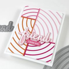 a close up of a card with the word friend on it and some metal scissors