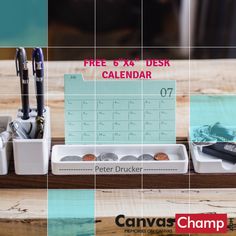 a desk calendar with pens, pencils and other office supplies on top of it