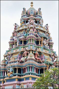 an ornate building with statues on it's sides