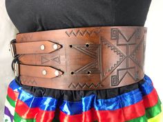 Our traditional hand-stamped leather belts are handcrafted with the utmost attention to detail and quality: Made from 9-10 oz vegetable-tanned leather (extremely thick) 4 inches wide Belts are adjustable up to 4 inches Intricate floral and geometric pattern stamping designs created by our Indigenous design team Hand dyed in-house in a range of natural finishes Require regular oiling to maintain durability and longevity (recommended oiling once a year) Custom-made: each belt will be slightly diff Traditional Leather Belt Buckle, Adjustable, Adjustable Leather Belt Buckles In Traditional Style, Adjustable Leather Belt Buckles, Traditional Style, Adjustable Traditional Leather Belt Buckles, Traditional Adjustable Leather Belt, Traditional Brown Leather Belt Buckles, Traditional Hand Tooled Leather Belt Buckles, Traditional Adjustable Brown Belt Buckles, Adjustable Brown Traditional Belt Buckles