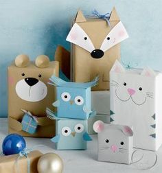 some paper bags with animals on them and one has a present box in the shape of a cat