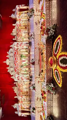 an elaborately decorated hall with red carpet and white walls is seen in this image